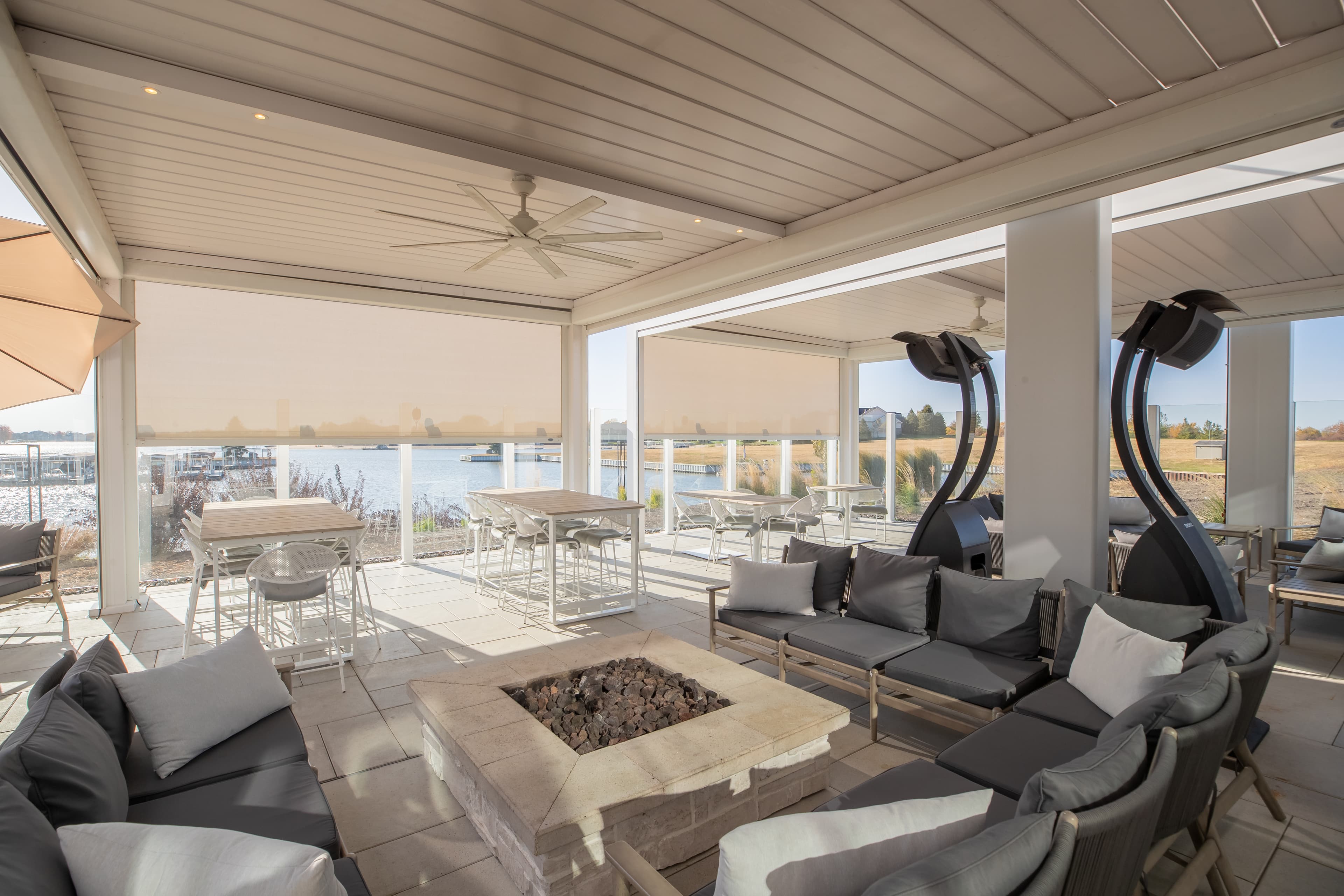 Commercial pergola with retractable shade screens overlooking lake