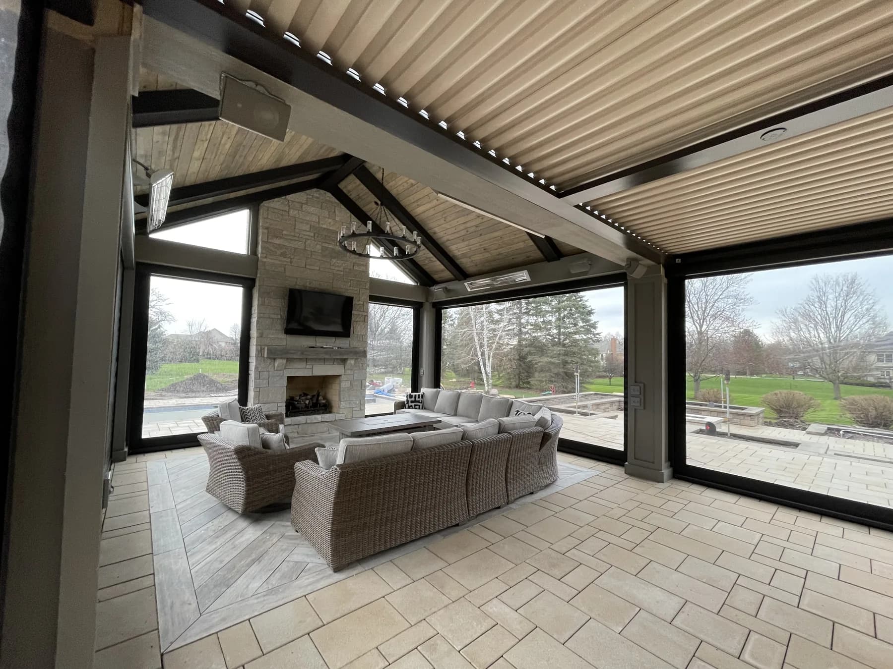 White louvered pergola over a furnished patio lounge