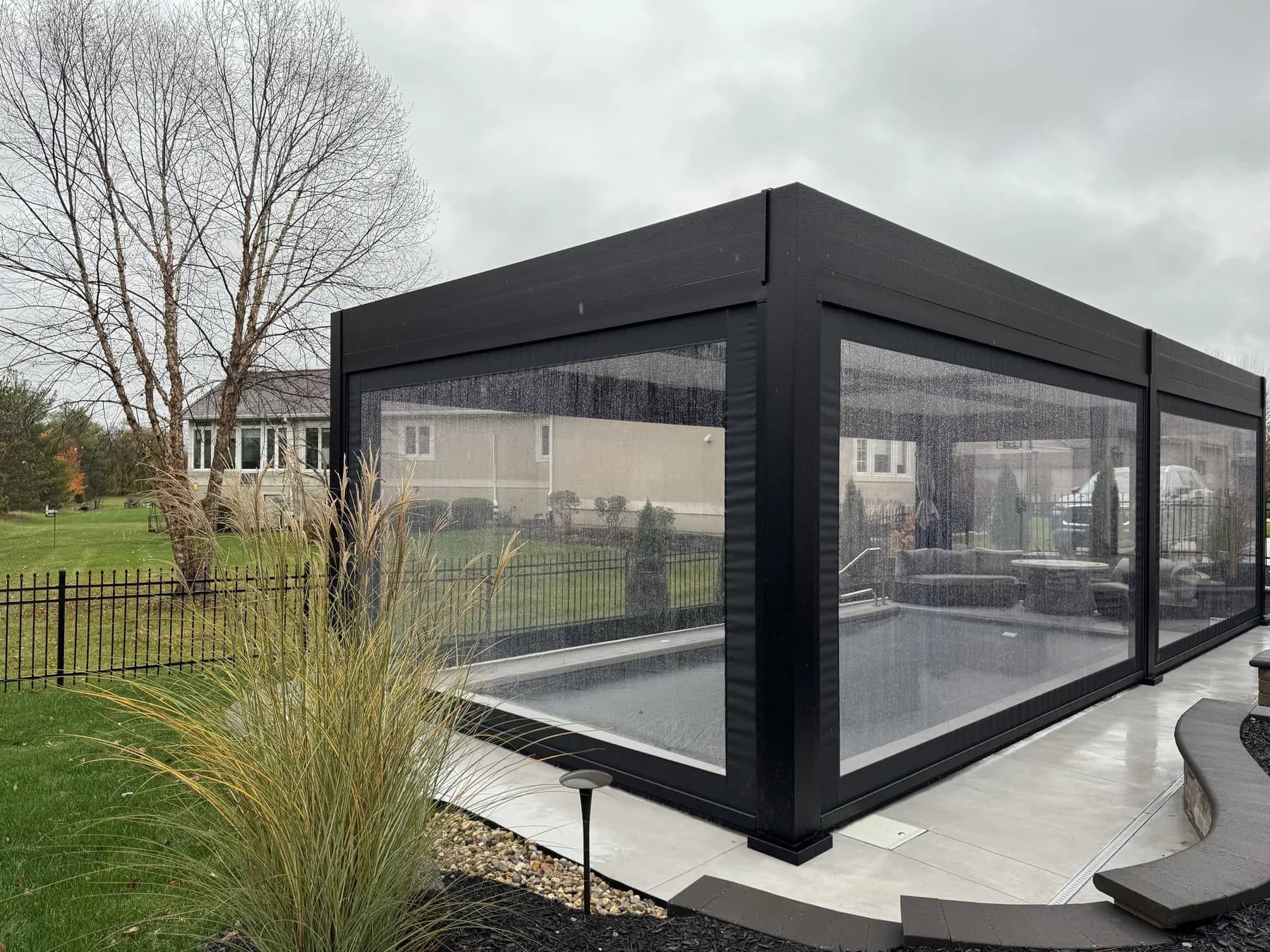 Covered backyard patio with lowered clear side panels