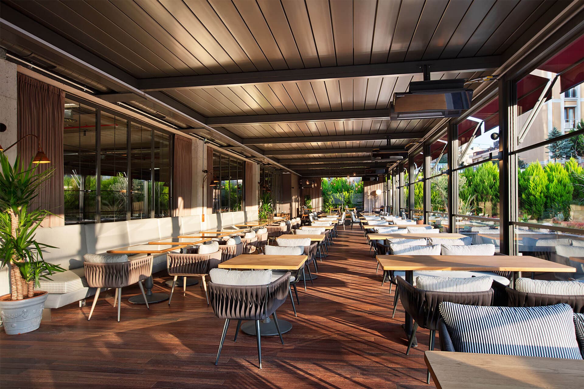 Pergola with glass enclosure panels for outdoor dining