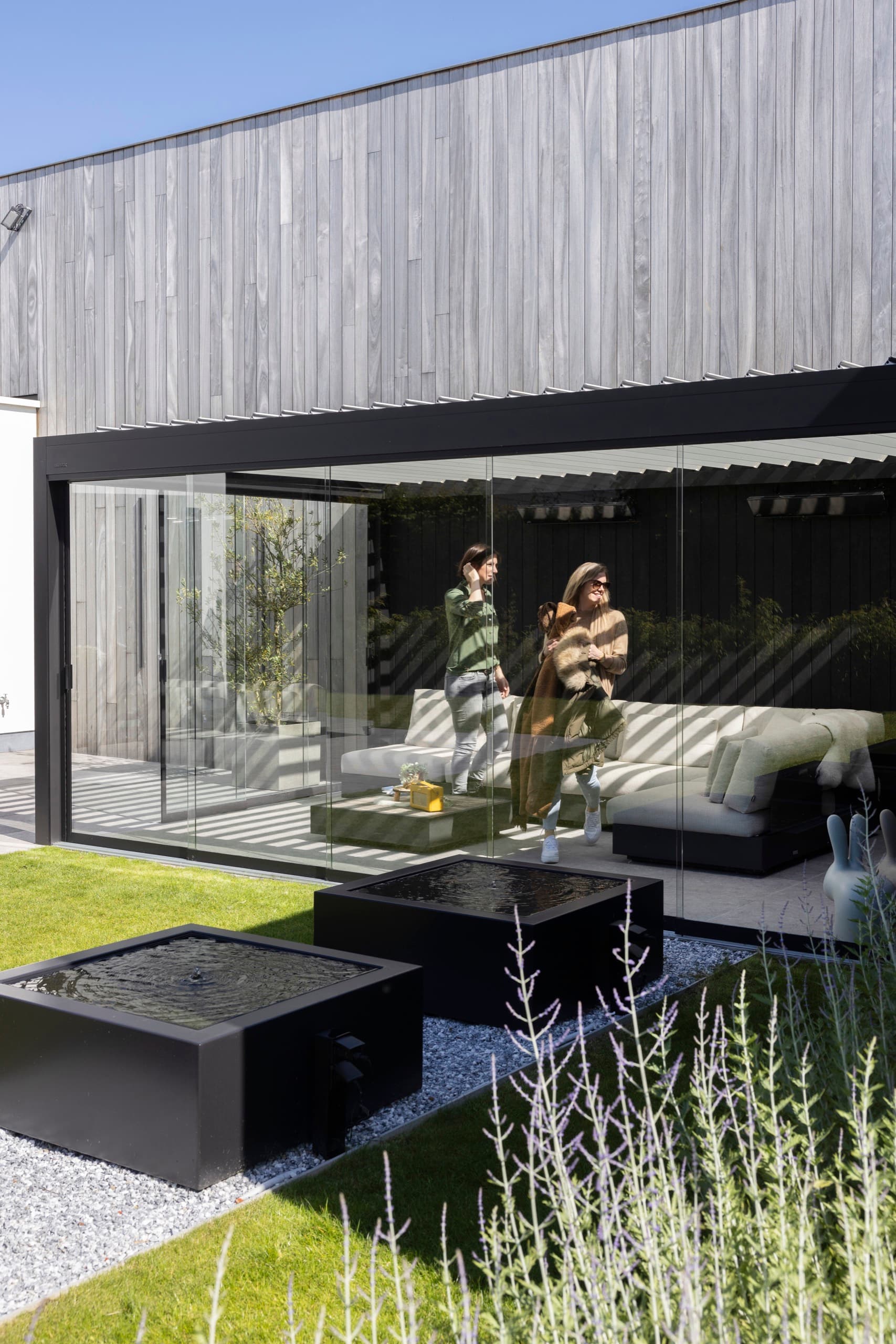 Frameless glass wall panels for a protected patio