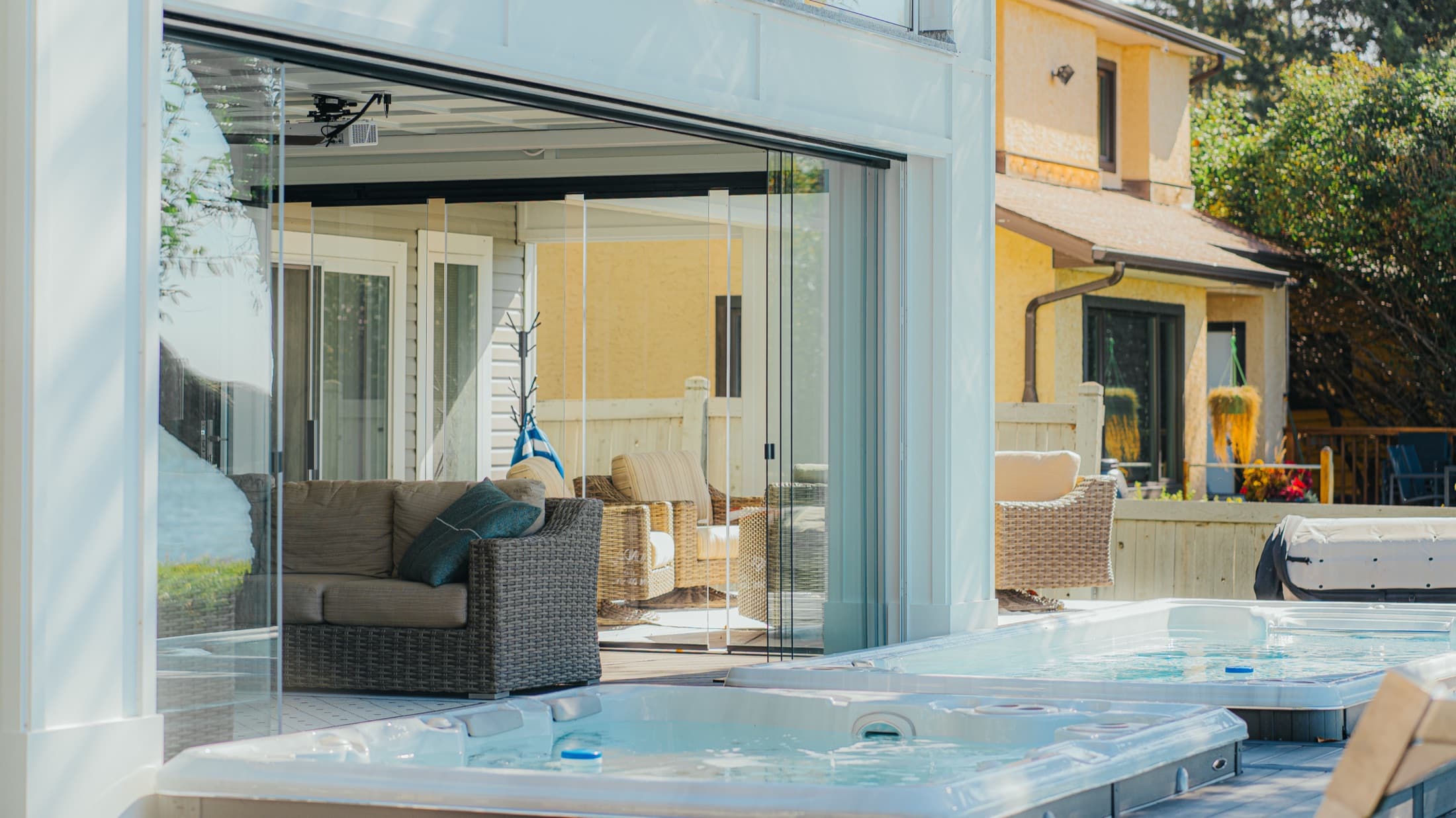 Lumon retractable glass enclosure around a covered patio