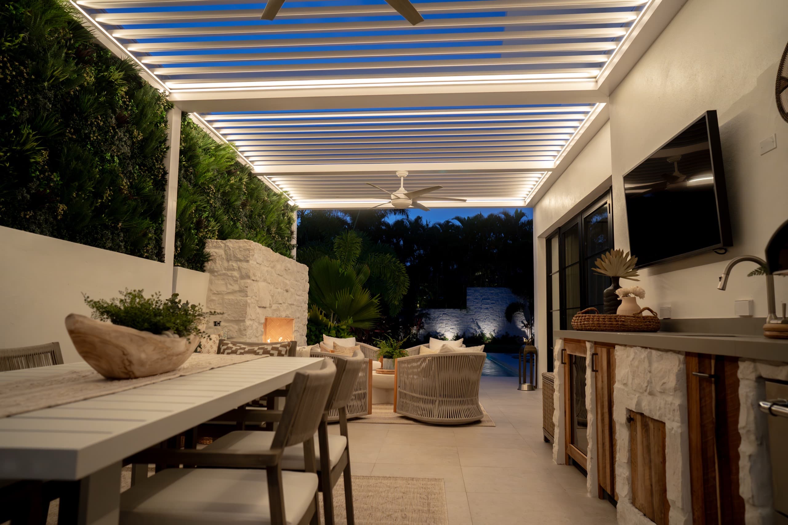 White motorized louvered pergola with integrated LED lighting