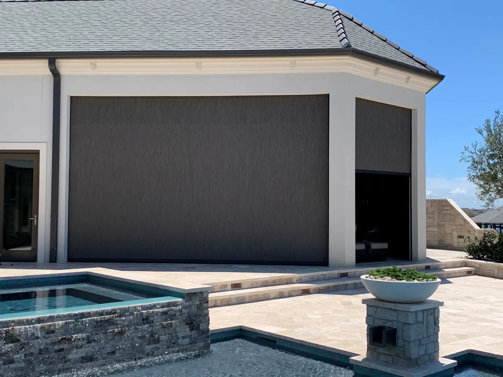Separate exterior screens lowered across a covered poolside patio