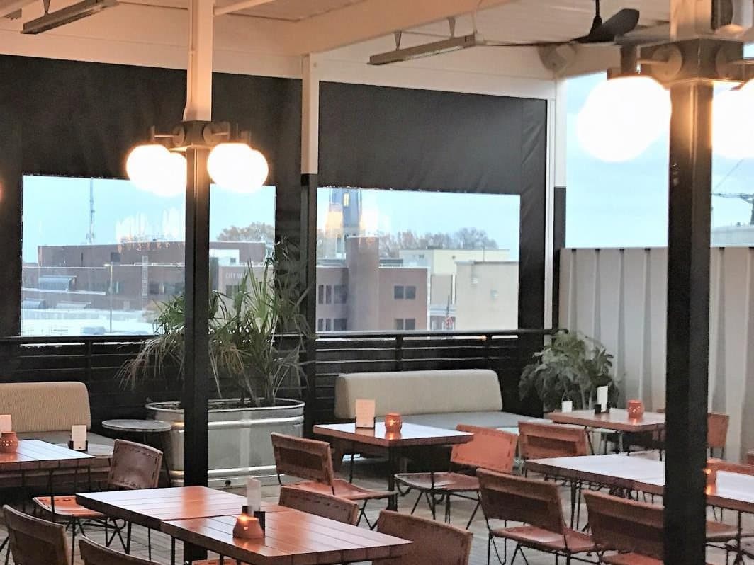 Commercial patio with retractable screens and guest seating