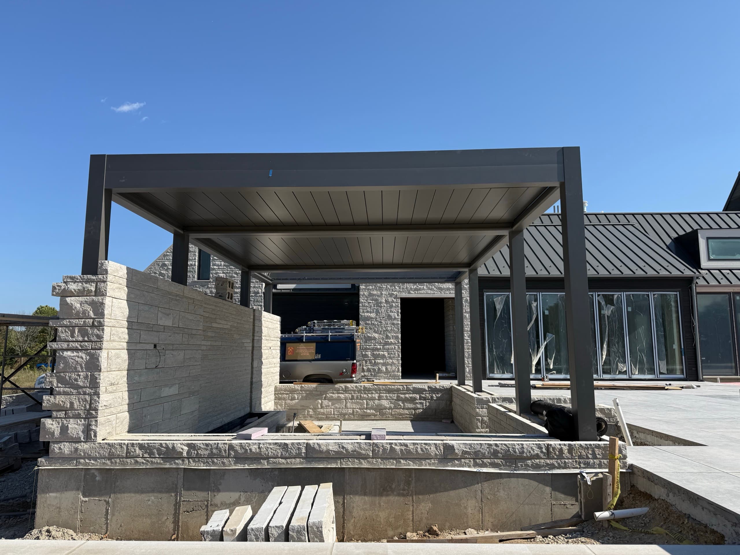 Motorized pergola structure over a sunken seating area in St. Charles
