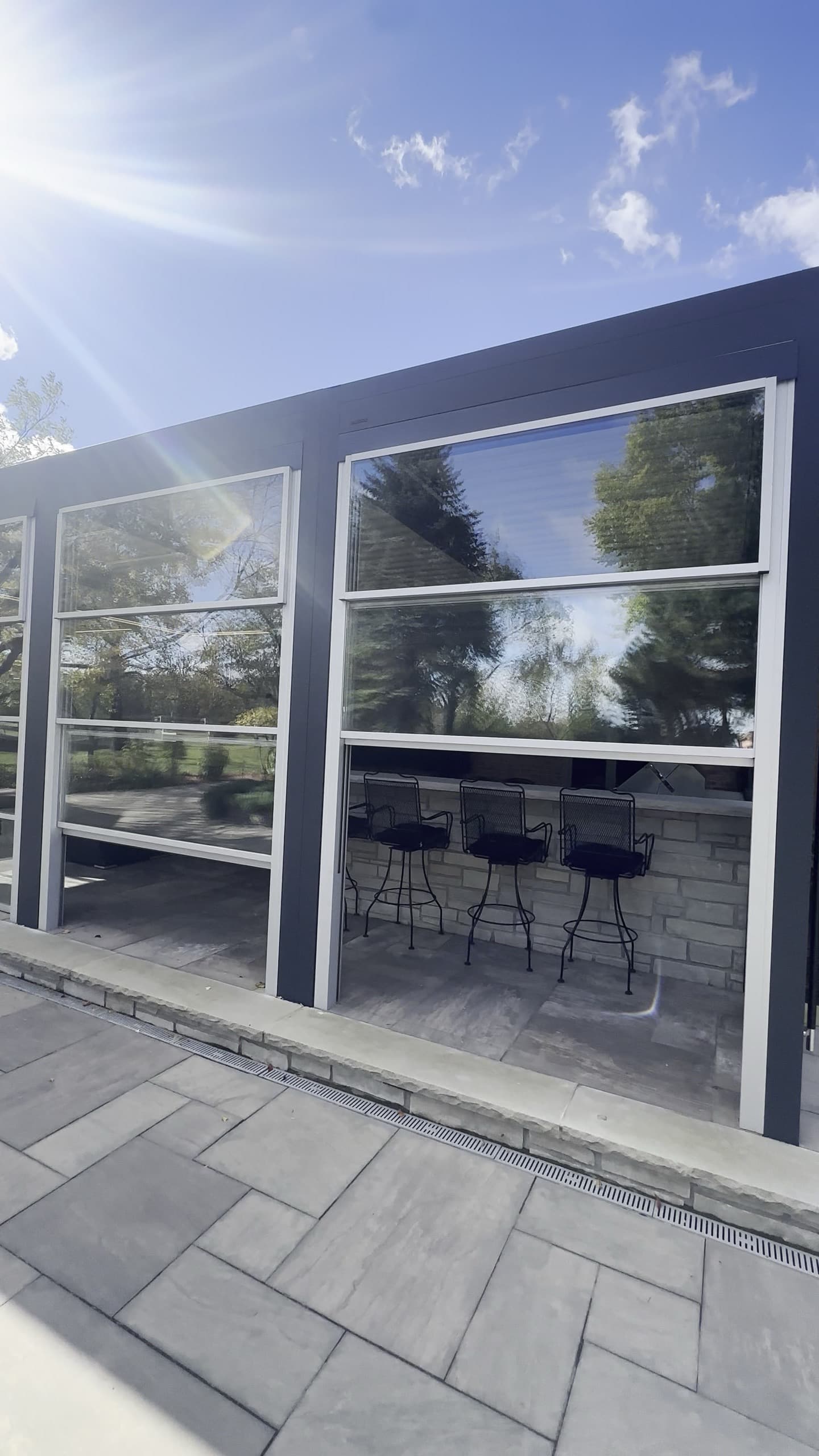 Outdoor room bar and seating under a pergola roof