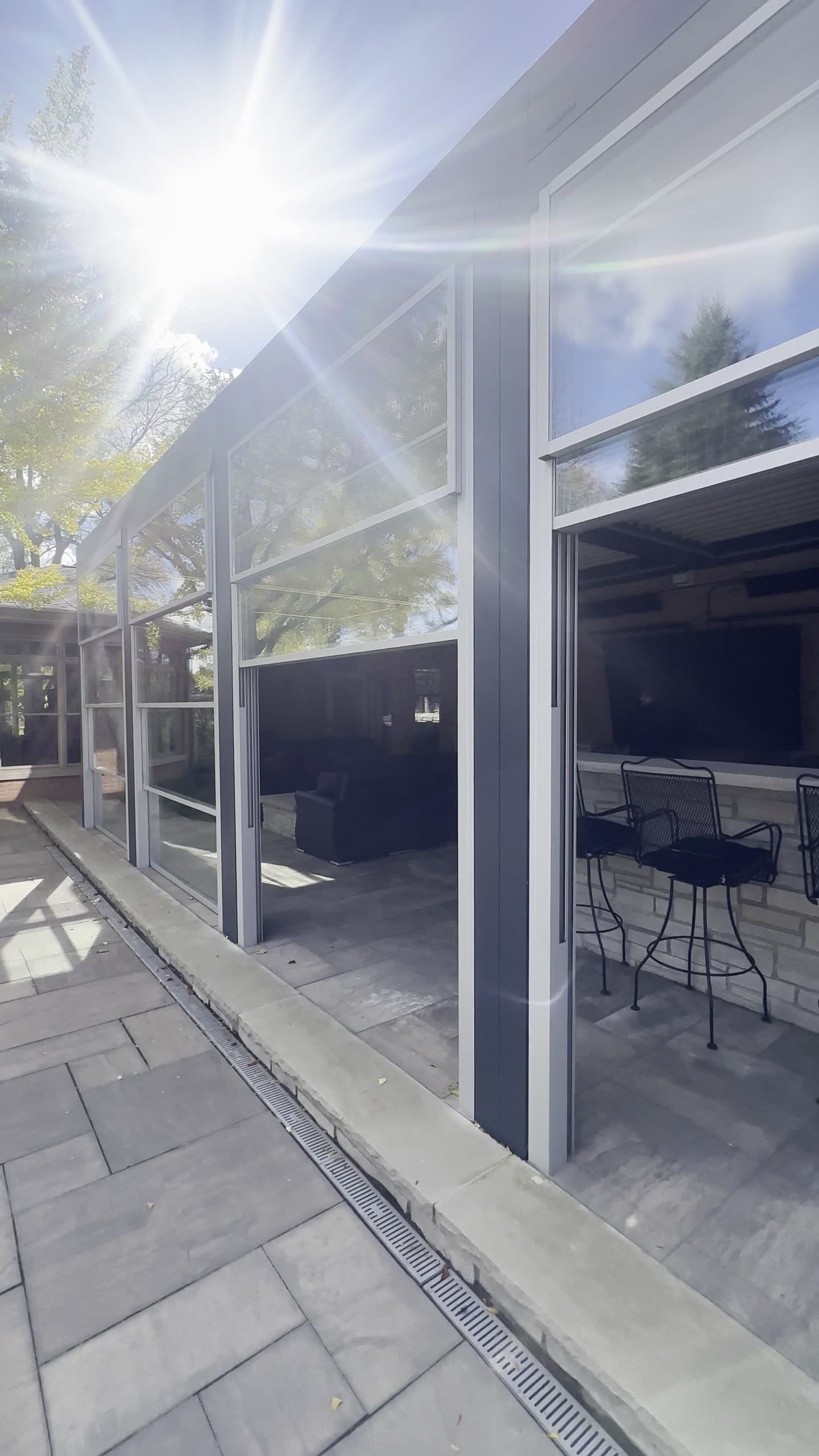 Outdoor room glass panels open for airflow